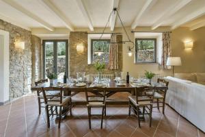 a dining room with a large wooden table and chairs at Lo Scarpellino in Bucine