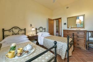 a bedroom with two beds and a table with a plate on it at Lo Scarpellino in Bucine +42 photos