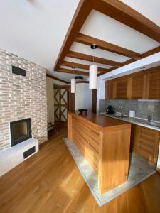 a kitchen with a fireplace and a wooden counter top at LUX apartman B432 Aparthotel Vučko Jahorina - private host in Jahorina