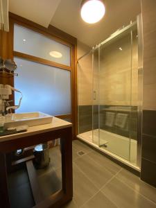 a bathroom with a glass shower and a sink at LUX apartman B432 Aparthotel Vučko Jahorina - private host in Jahorina +26 photos