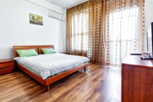 a bedroom with a bed and a large window at 423 Апартаменты в центре Отлично подходят для командированных и туристов in Almaty