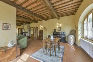 an open living room with a table and a couch at Villa di Capannole 12 in Bucine