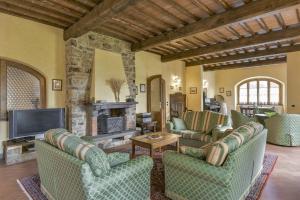a living room with couches and a fireplace at Villa di Capannole 12 in Bucine