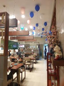 a restaurant with blue balloons hanging from the ceiling at Phạm Vân Sakura Hotel in Thuan An