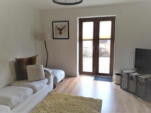 a living room with a couch and a tv at Demesnes View in Barnard Castle