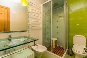 a bathroom with a sink and a toilet and a shower at 4 bedroom villa wi-fi and shared pool by ALGARVEMANTA in Manta Rota +16 photos
