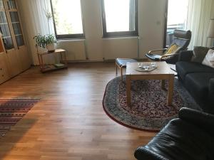 a living room with a couch and a coffee table at Ferienwohnungen Am Elfenstein in Bad Harzburg