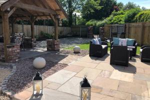 a patio with chairs and a gazebo at Dove Nest Cottage Blackpool Lytham St Annes in Lytham St Annes