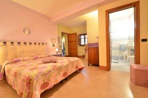 a bedroom with a large bed and a bathroom at Francesca 3 in Camaiore