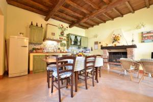 a kitchen with a table and chairs and a refrigerator at Francesca 3 in Camaiore