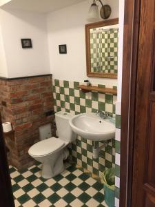 La salle de bains est pourvue de toilettes et d'un lavabo. dans l'établissement Pensjonat Stary Spichlerz, à Ełk
