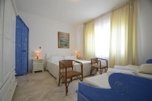 Ένα ή περισσότερα κρεβάτια σε δωμάτιο στο Le Finestre