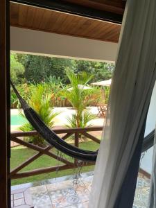a hammock on the balcony of a house at Pousada Villa Dos Sonhos in Itacaré