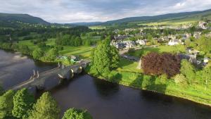 an aerial view of a river with a bridge at Schiehallion Luxury Glamping Pod with Hot Tub at Pitilie Pods in Aberfeldy