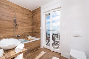 a bathroom with a tub and a sink at Villa Ines in Ičići