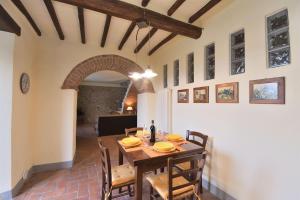 a dining room with a wooden table and chairs at La Rana in Gaiole in Chianti