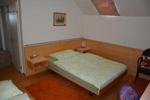 a bedroom with a bed and a table and a chair at Hotel Hessengüetli in Winterthur