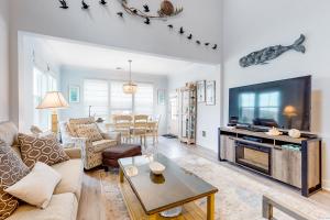 a living room with a couch and a tv at Bayside Resort - 28031 Sea Dock in Selbyville