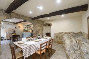 a kitchen and dining room with a table and chairs at Podere Terrena in Gaiole in Chianti