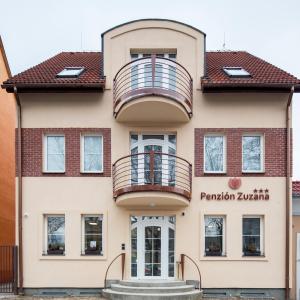 a building with a balcony in front of it at Penzion Zuzana in Ružomberok