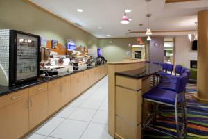 a fast food restaurant with a counter and blue stools at Holiday Inn Express Hotel & Suites Rock Springs Green River, an IHG Hotel in Rock Springs