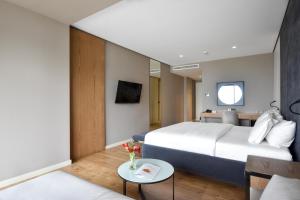 a hotel room with a bed and a table at Yacht Hotel in Vlorë