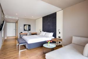 a hotel room with a bed and a couch at Yacht Hotel in Vlorë