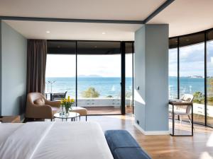a bedroom with a bed and a view of the ocean at Yacht Hotel in Vlorë