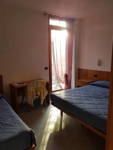 Postel nebo postele na pokoji v ubytování Hotel Rezia