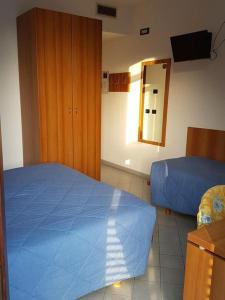 Postel nebo postele na pokoji v ubytování Hotel Rezia