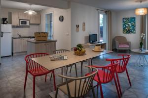 uma cozinha e sala de estar com mesa e cadeiras em Le Domaine du Golf*** by Ateya Vacances em Fabrègues