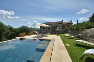 a swimming pool in front of a house at Le Cerreta in Gaiole in Chianti