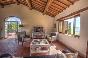 a living room with two chairs and a table at Le Cerreta in Gaiole in Chianti