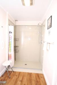 a bathroom with a shower with a wooden floor at E Huron 401 in Folly Beach