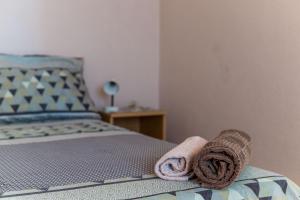 a towel laying on the end of a bed at Apartment Angelina in Dubrovnik