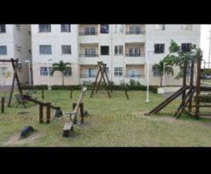 an empty playground in front of a large building at Apartamento Aruana a 3 Km da praia in Atalaia Velha +8 photos
