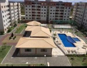 a view of a building with a swimming pool at Apartamento Aruana a 3 Km da praia in Atalaia Velha