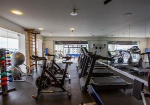 a gym with several treadmills and exercise bikes in it at Estanplaza Ibirapuera in São Paulo