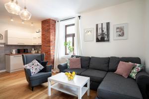 a living room with a couch and a table at Apartamenty Dukla in Dukla