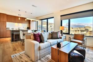 a living room with a couch and a table at Modern 1BR Residence in Canyons VillageSki In Out in Park City