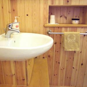 a bathroom with a white sink and wooden walls at Dilston Mill in Hexham +13 photos