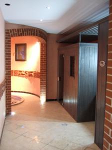 a hallway with a door and a brick wall at Domaine de Gaudon in Ceilloux