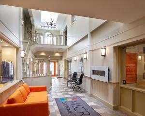 a lobby with a couch and chairs in a building at Micro Boutique Living Antigonish in Antigonish