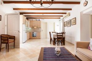 a kitchen and living room with a table and chairs at Beautiful Holiday House near the sea in Sissi