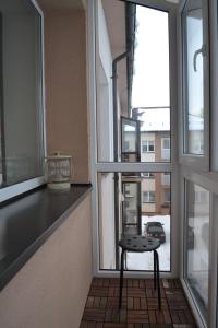 a small stool sitting in front of a window at Šaulys in Druskininkai