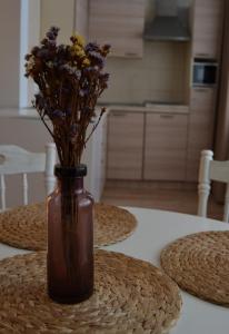 a vase with flowers in it sitting on a table at Šaulys in Druskininkai