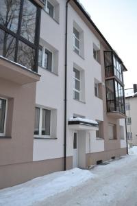 an apartment building with snow on the ground at Šaulys in Druskininkai