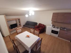 a small kitchen and living room with a table and chairs at Baka Ljuba in Grabarje
