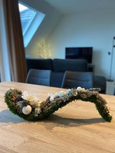 a branch with shells on top of a table at Appartement Anne-Rose in Beernem