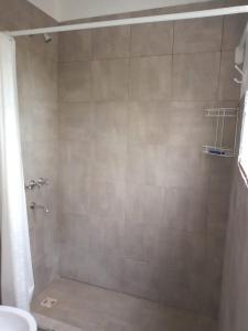 a bathroom with a shower with a toilet and a sink at La Casa del Molino in Ramallo